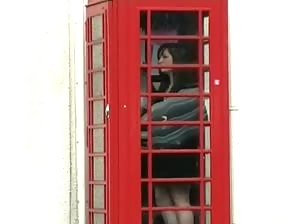 Sweet Ed using a public phonebooth naked